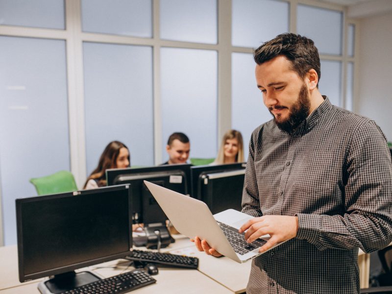 Workers at an IT company working on a computer